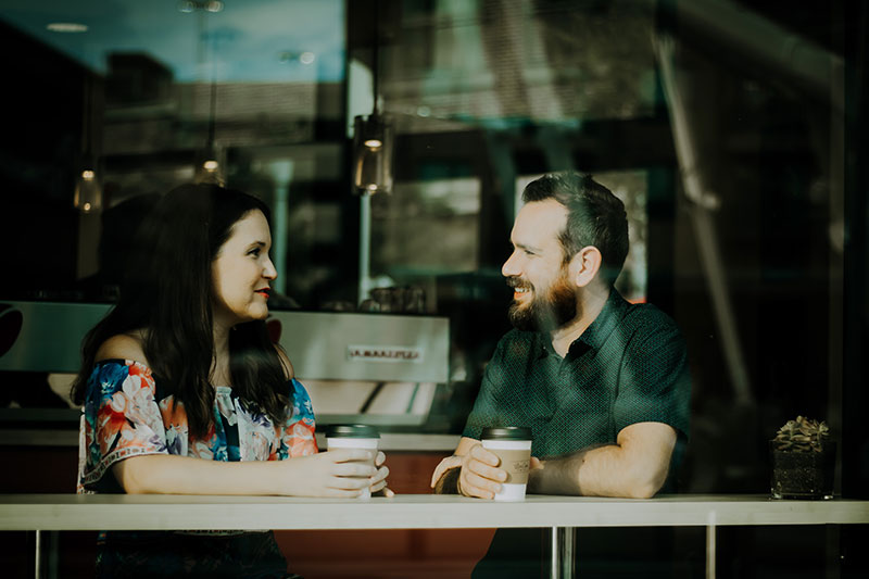 photo of woman and man sitting at a cafe